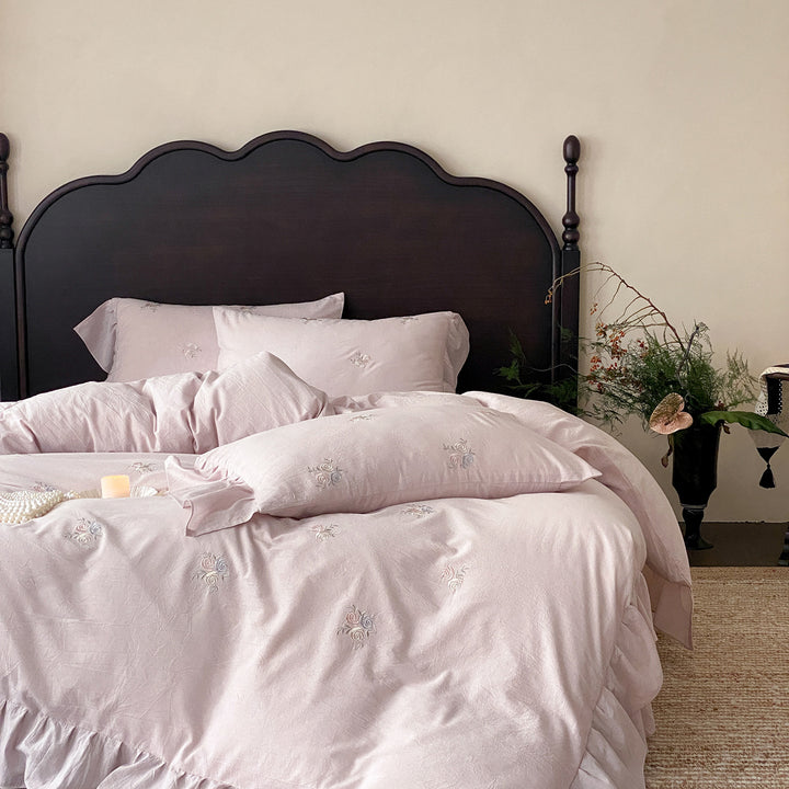 Vintage-inspired linen bedding set with fine rose embroidery and soft wash finish
