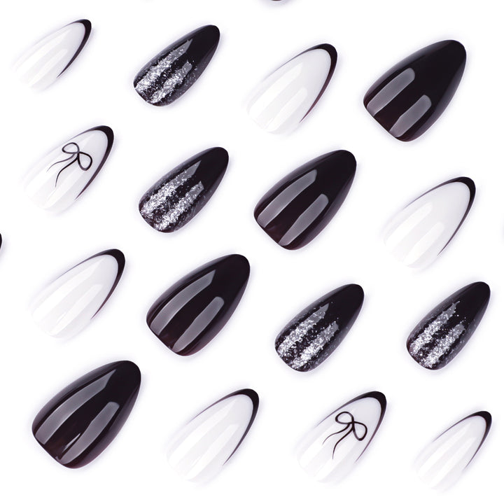 Artful nail art with elegant bow pattern and glitter accents Kalsten