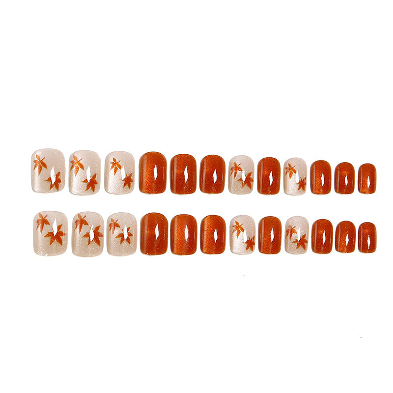 Artificial nails with glamorous ombre design and autumn leaf applications Kalsten
