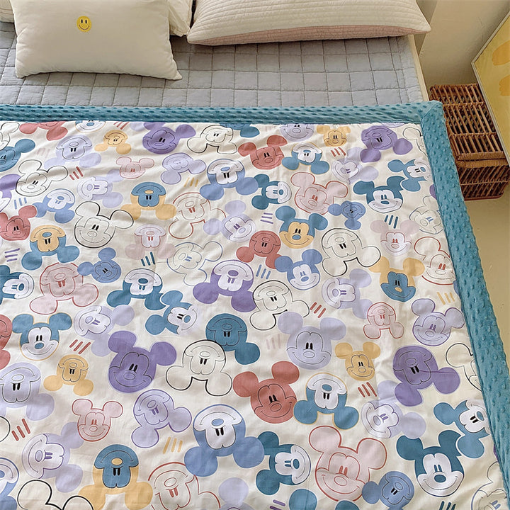 Children's quilt with colorful dinosaur print and soft minky border