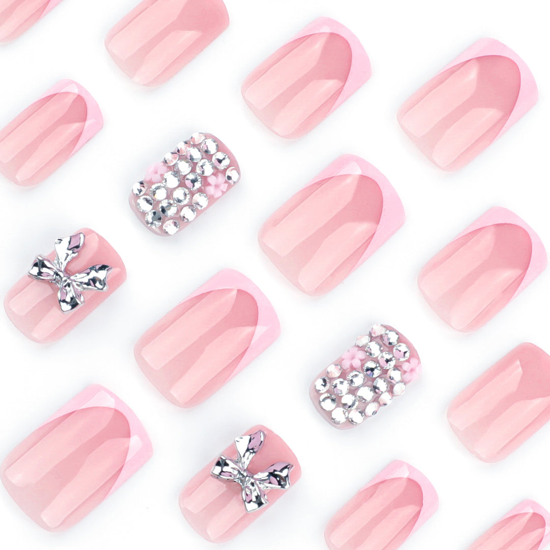 Artful nail art with glitter accents and bow decoration Kalsten