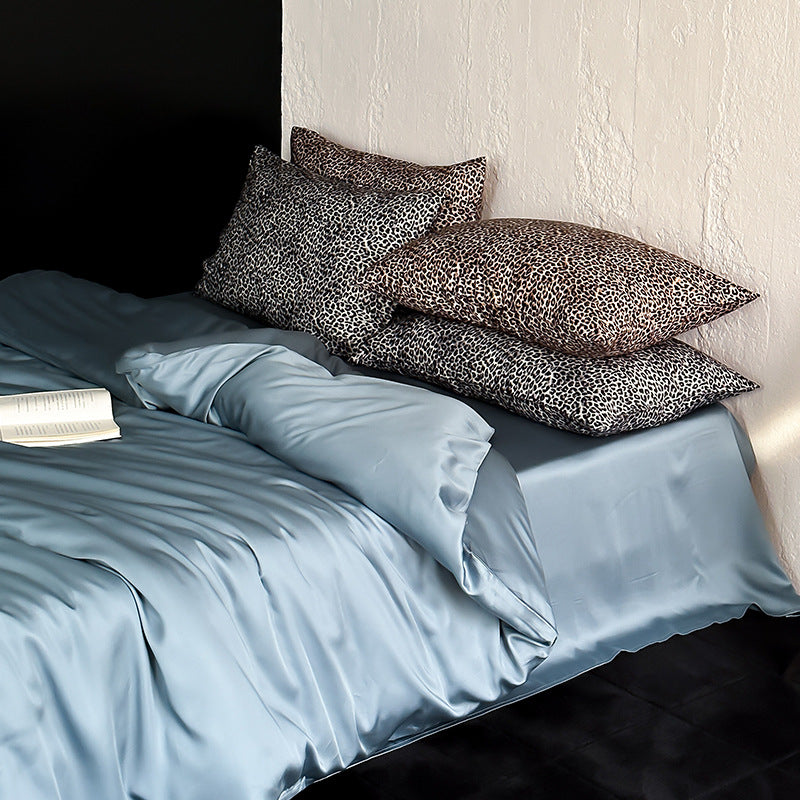 Satin bedding set with a silky sheen, smooth drape, and animal print pillows