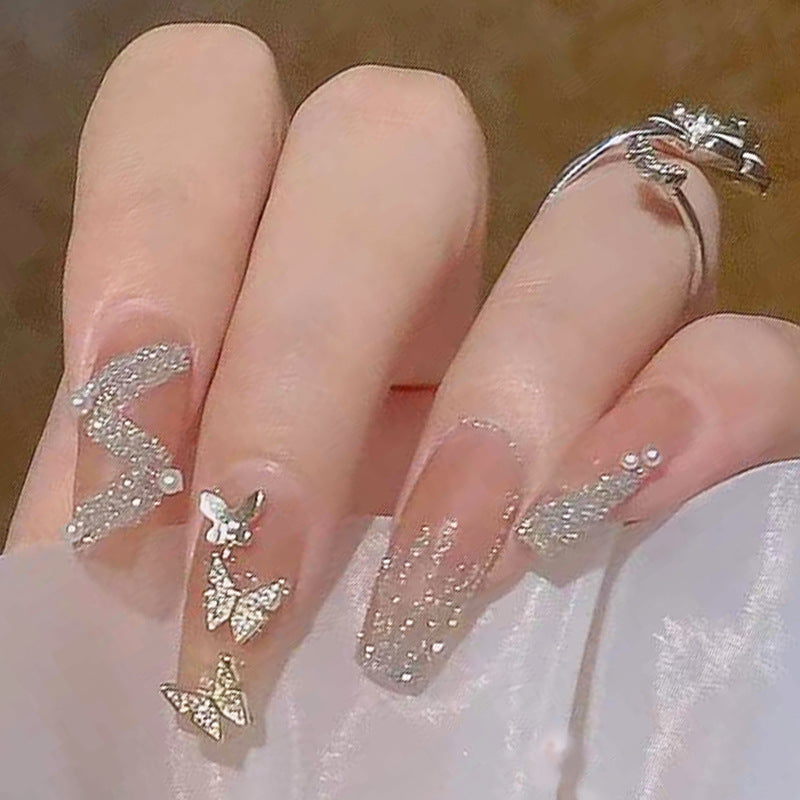 Artificial nails with sparkling rhinestone and bow accents Kalsten