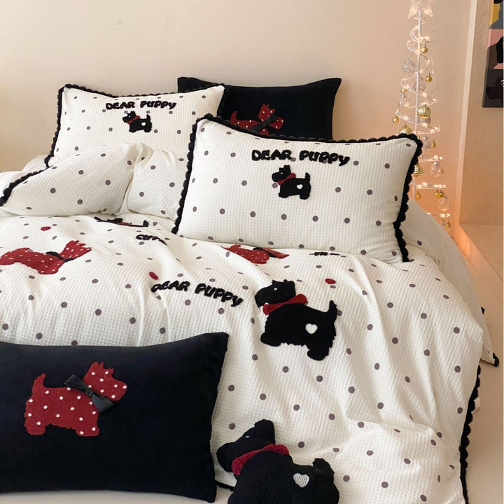 Quilted bedspread and pillow set with embroidered puppy motifs