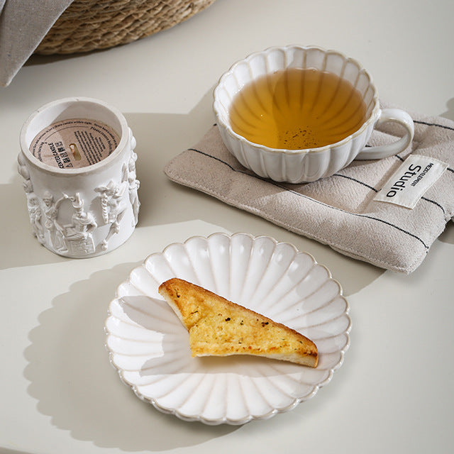 Fine porcelain tea cup set with ribbed shell edge and sculptural handle