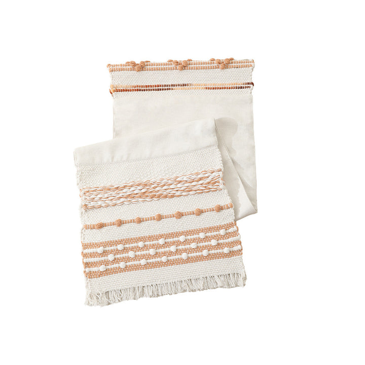 Woven cotton table runner with textured tufting and fringed border