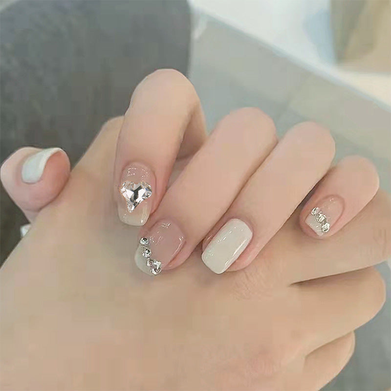Glamorous artificial nails with heart and rhinestone decorations Kalsten