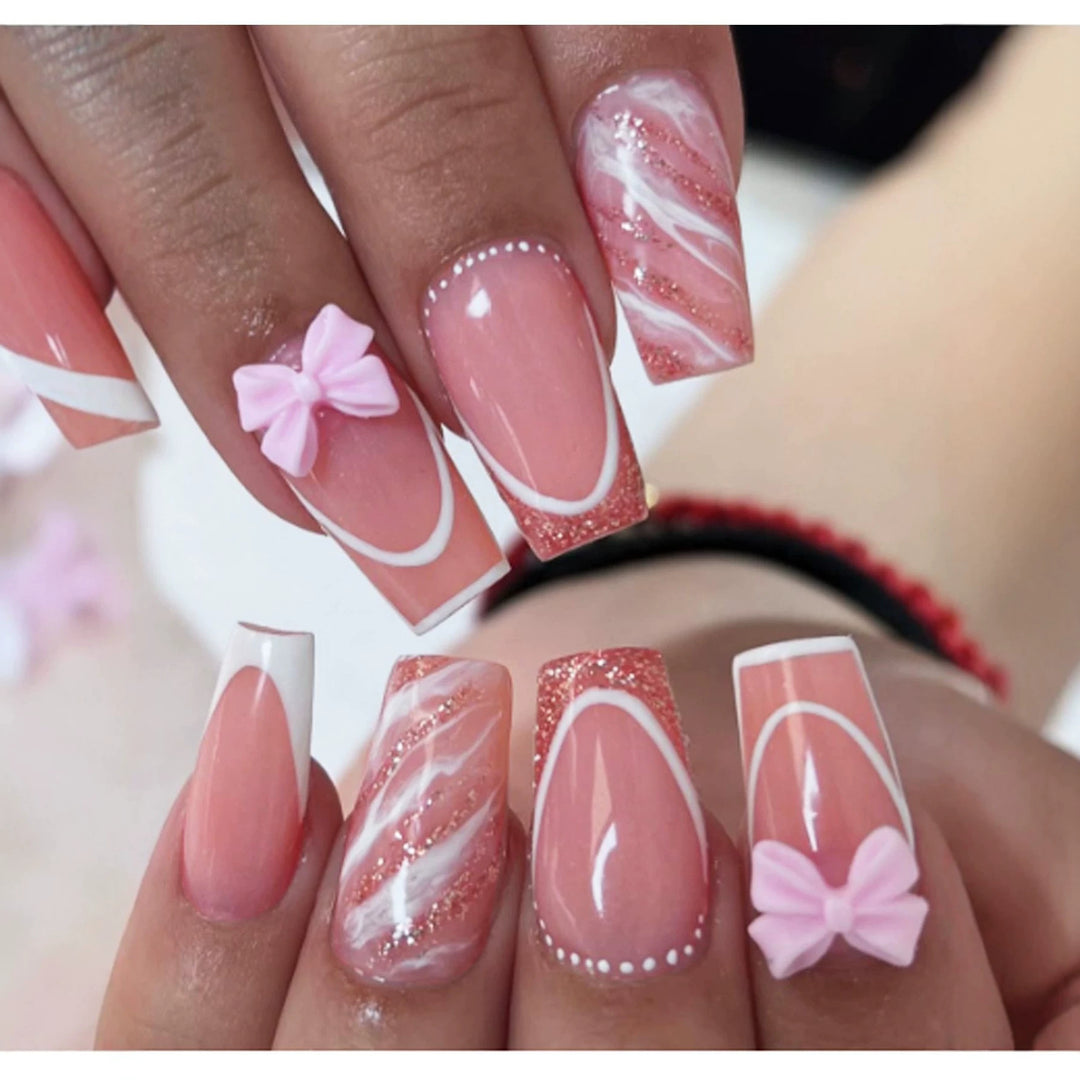 Acrylic nail set with elegant glitter design and playful bow accents Kalsten