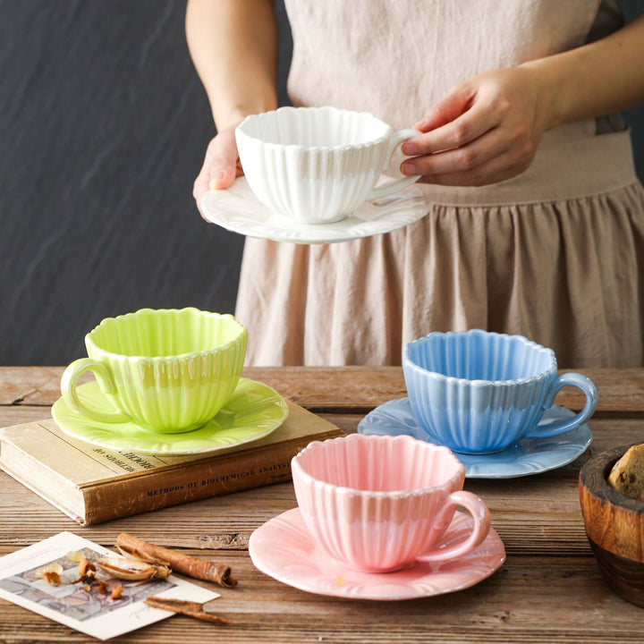 Fine porcelain tea cup with ribbed shell shape and matching saucer
