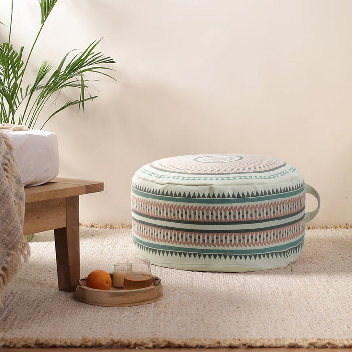 Round padded floor seat pouf with woven ethnic pattern and carrying handle Kalsten