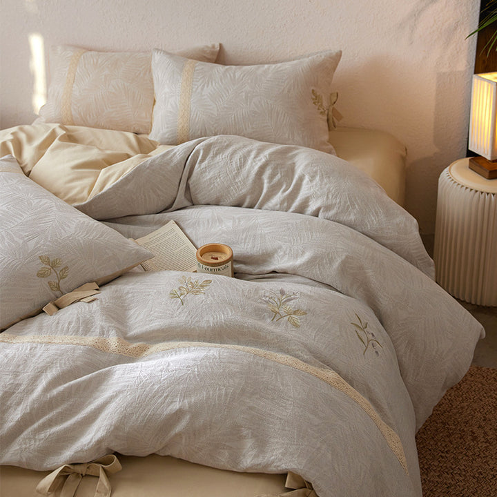 Premium cotton duvet cover with floral embroidery, lace trim and ribbon closure