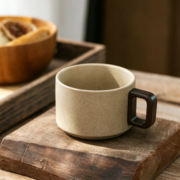 Ceramic mug with wooden handle and saucer