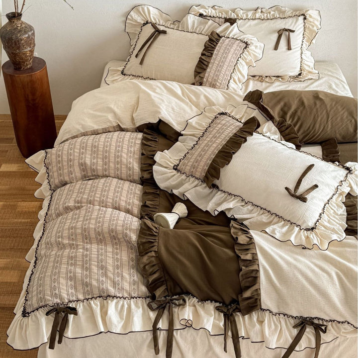 Country house style cotton-linen bedding set with ruffles, striped bedspread and decorative pillow