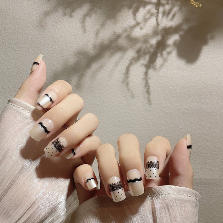 Artistic Press-On Nail Design with Lace and Polka Dots