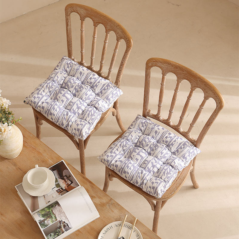 Padded quilted seat cushion with colorful button applications and non-slip underside Kalsten