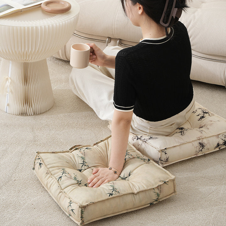 Padded seat cushion with tufting and bamboo motif