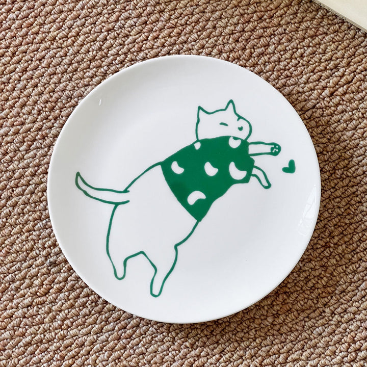 Decorative ceramic plate with cat motif and green border decoration