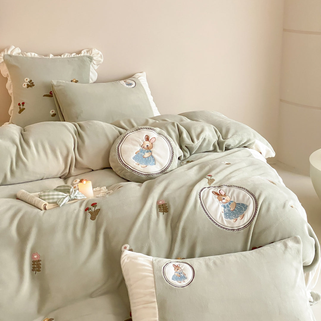 Quilted children's bedding set with embroidered bunny appliqués and ruffles