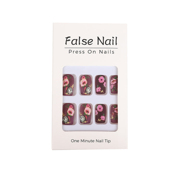 Nail art with floral design and intricate clock motifs Kalsten