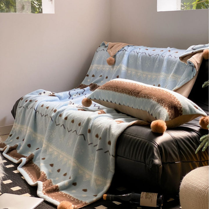 Soft blanket made of microfleece with pompom and Nordic bear pattern