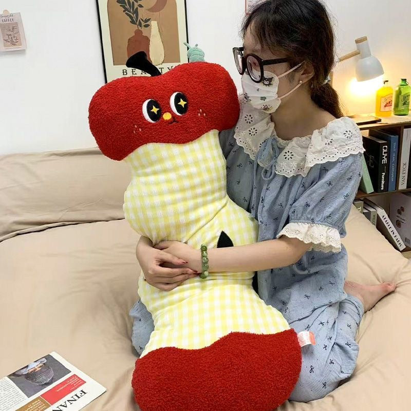 Extra-long ergonomic cuddle body pillow in apple core design with gingham cover and soft plush ends
