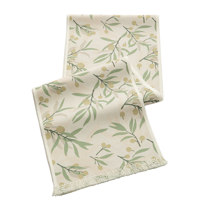 Woven botanical table runner with olive branch motif and fringed edge