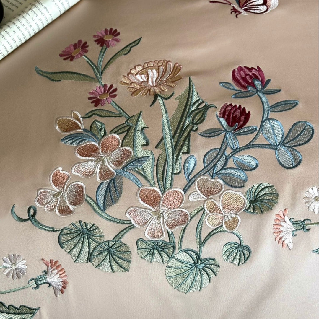 Luxurious embroidered satin bedding set with contrast piping and decorative pillow