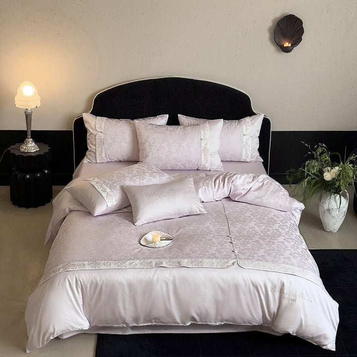Romantic satin bedding set with embroidered floral design, ruffle and pillowcases