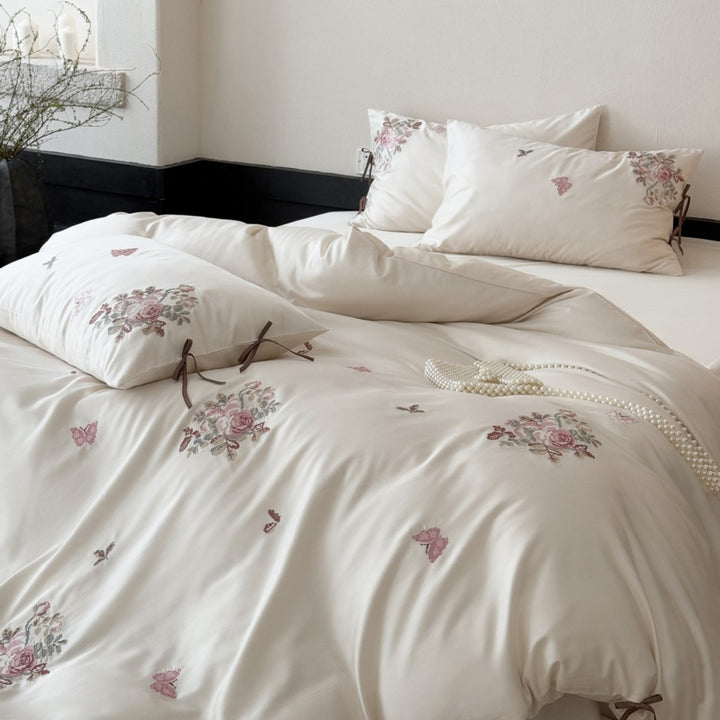 Silky-matte satin bedding set with embroidered rose bouquets and ties