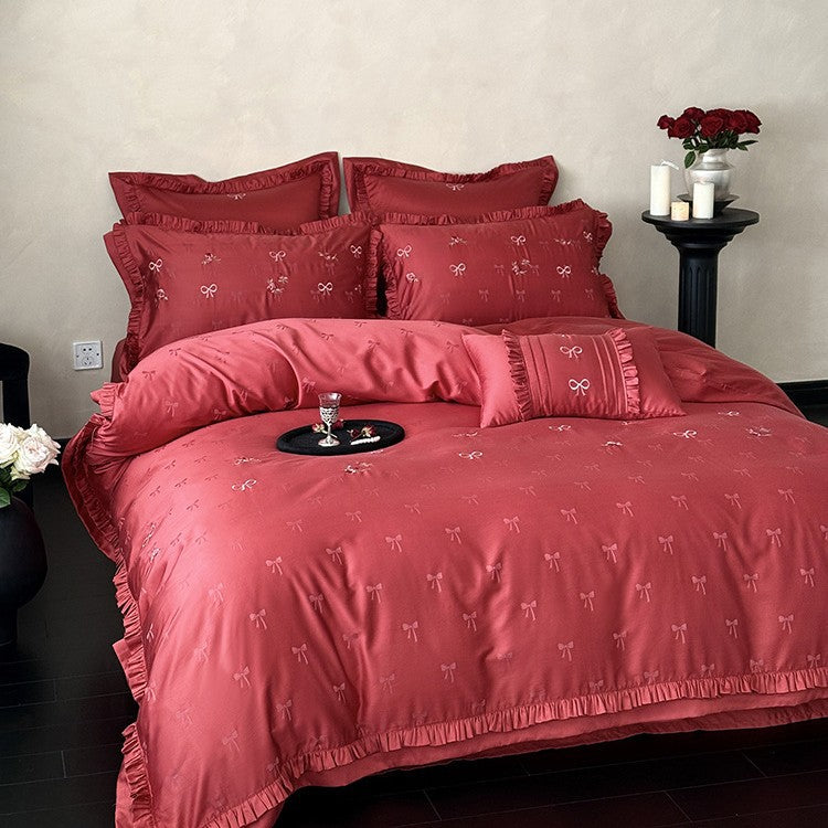 Luxurious satin bedding set with delicate floral embroidery and ruffles