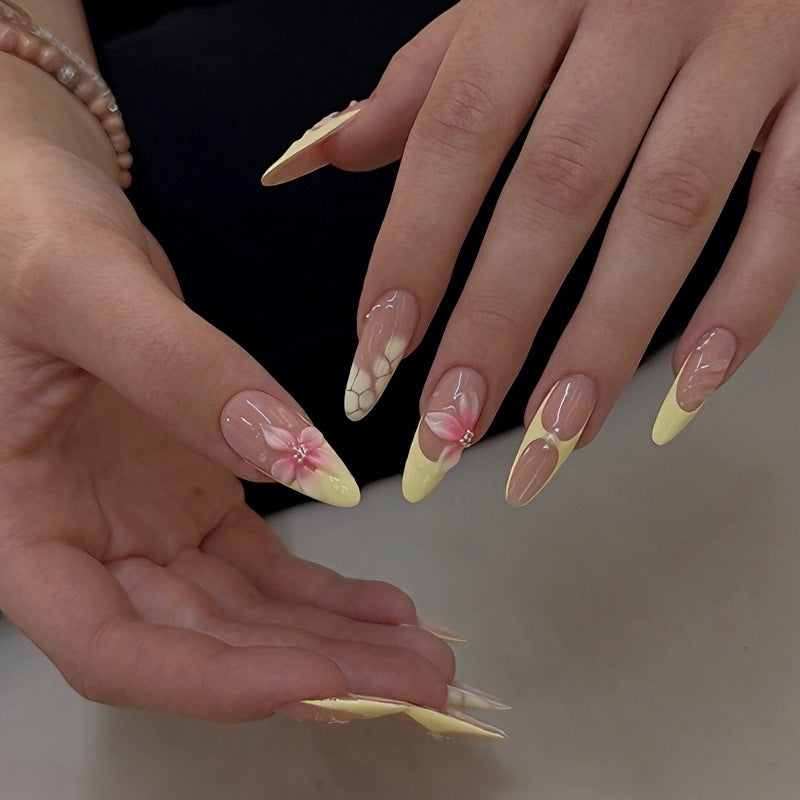 Acrylic nail set with elegant floral pattern and shimmering accents Kalsten