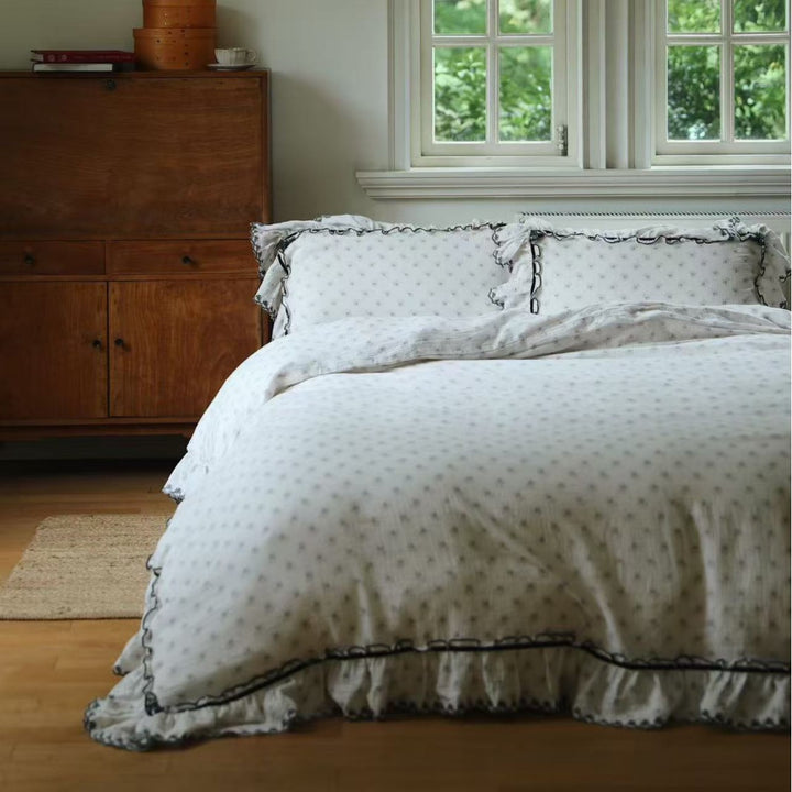 Luxurious bed linen set made of cotton gauze with quilted blanket and lace trim
