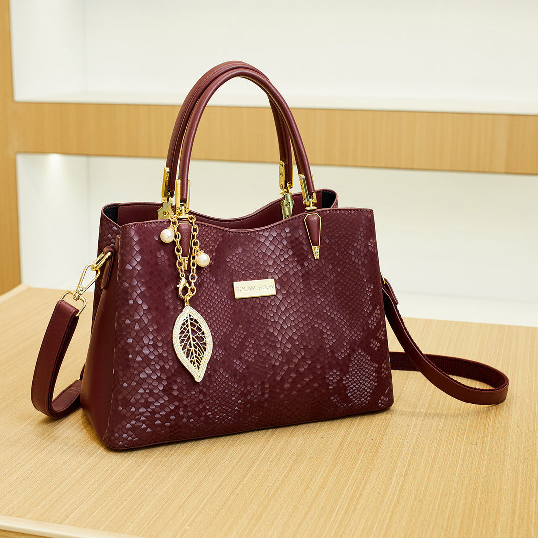 Elegant Designer Handbag with Decorative Charm