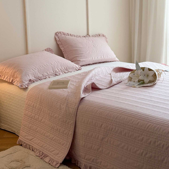 Quilted bedspread with frill and fine line quilting made of cotton blend fabric