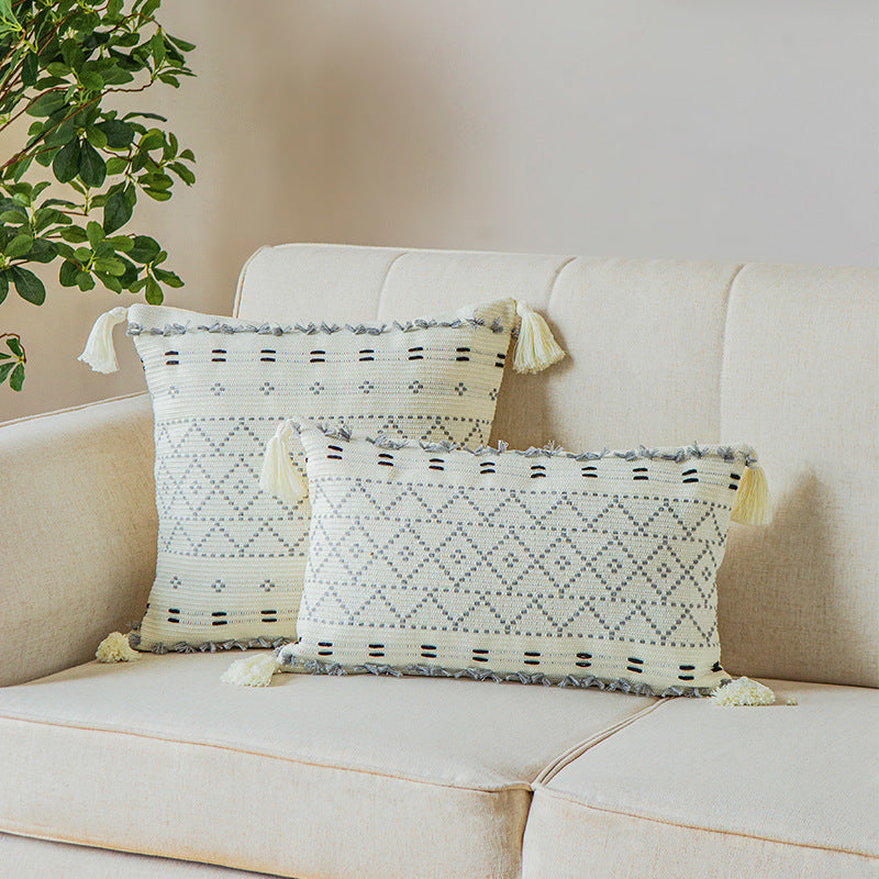 Square decorative cushion cover made of cotton blend with hand-tufted geometric relief and tassels