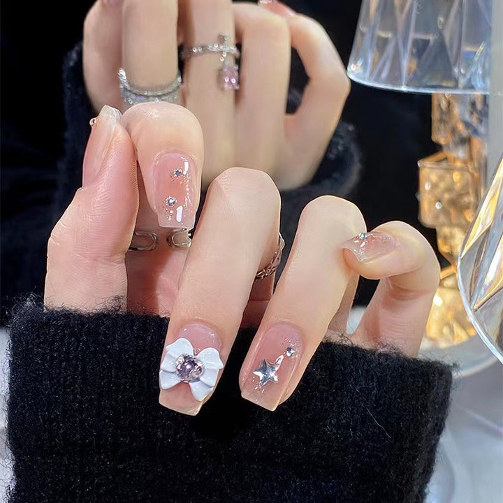Artistic nail tips with floral and glittering accents Kalsten