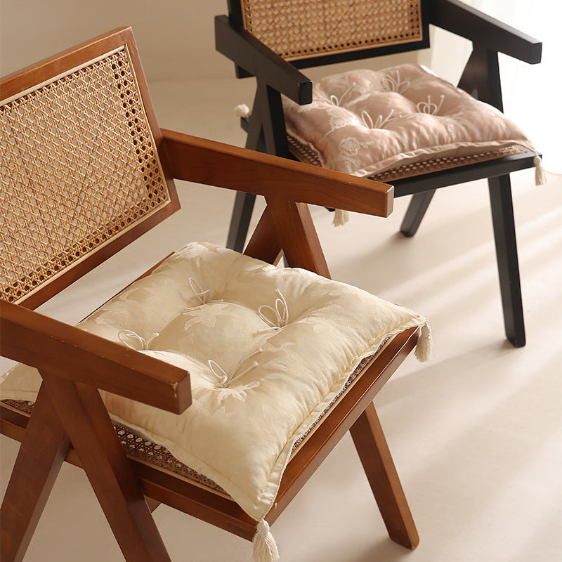 Padded floor cushion with quilted tufting and tassels