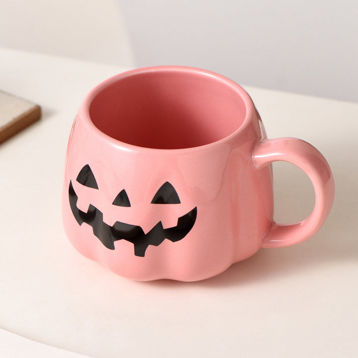 Ceramic mug in pumpkin shape with handle and carved face