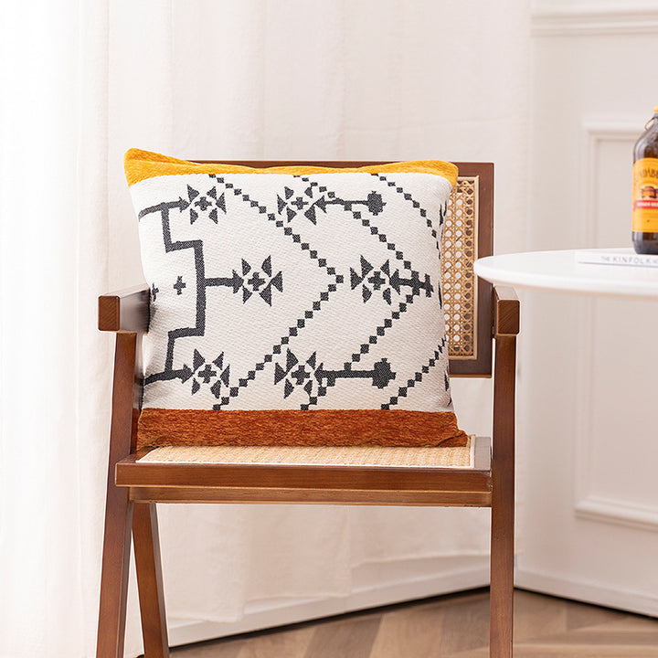 Woven cushion cover with graphic ethnic pattern and contrasting borders