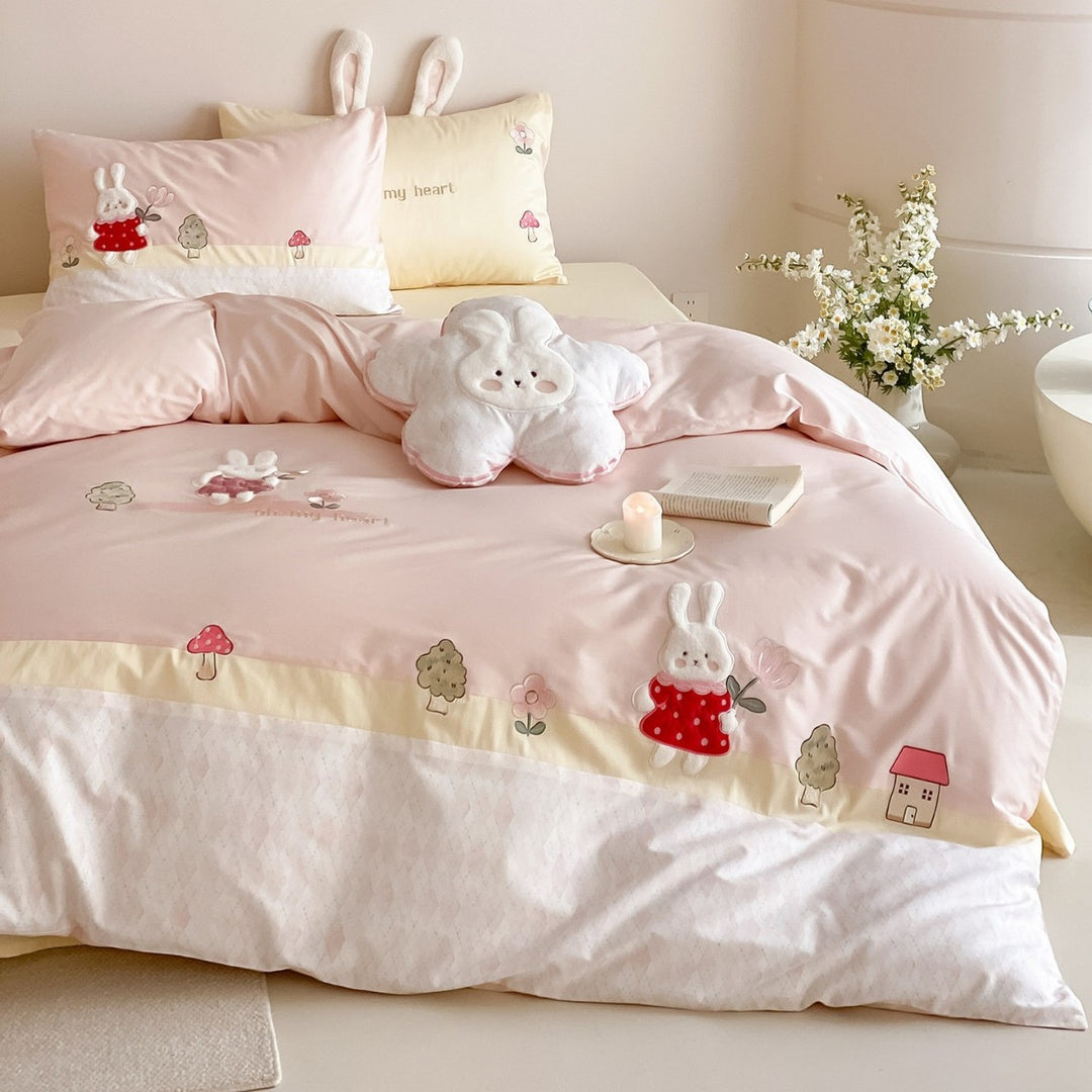 Playful cotton satin bed linen set with embroidered bunny appliqués and plush pillow