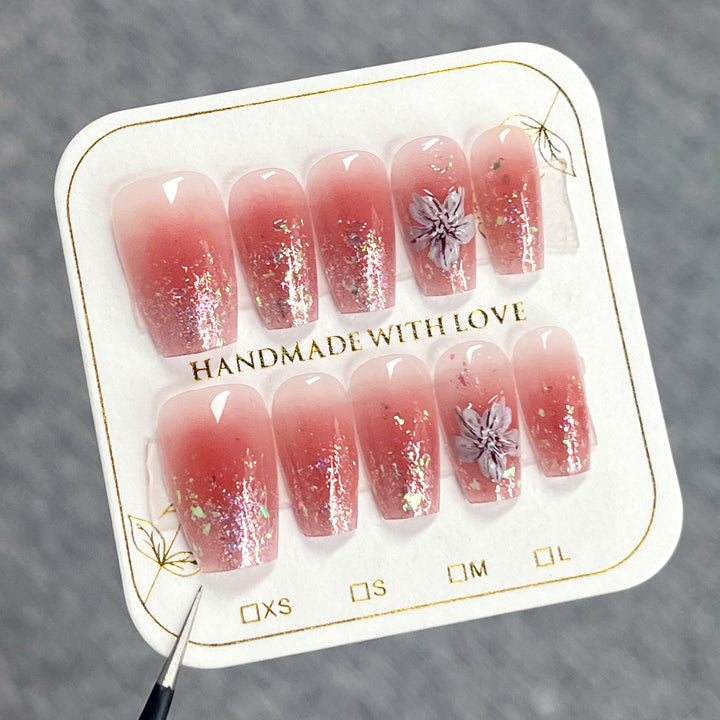 Artificial nail extensions with floral design and glitter accents Kalsten