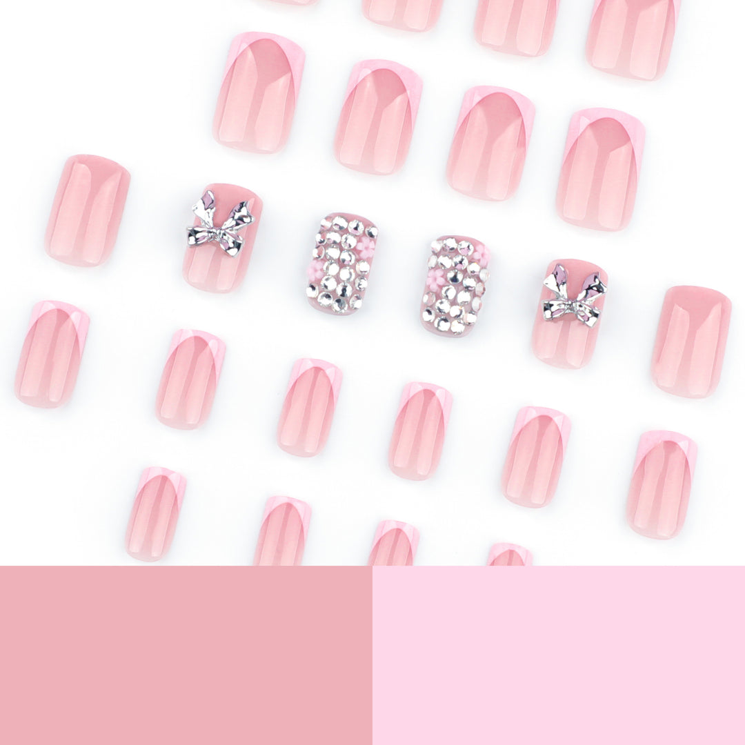 Artful nail art with glitter accents and bow decoration Kalsten