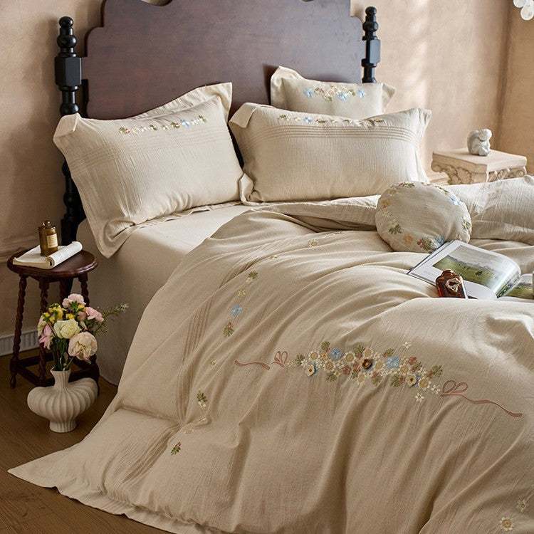 Soft cotton gauze bed set with hand-stitched flowers and decorative ruffle
