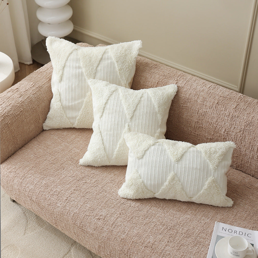 Square decorative pillow with tufted triangle structure and bouclé surface