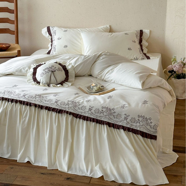 High-quality embroidered bedding set with ruffled bed skirt and decorative cushion