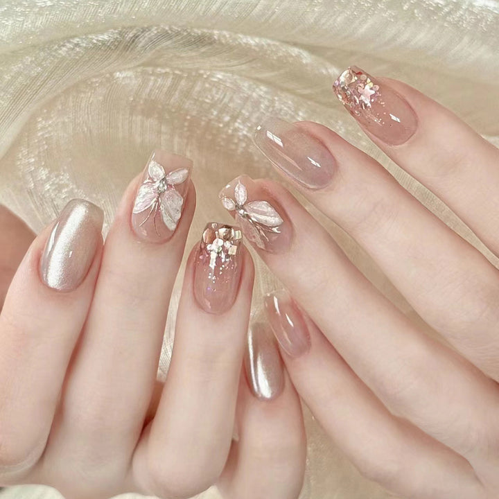 Artful nail art with butterfly designs and glitter accents Kalsten