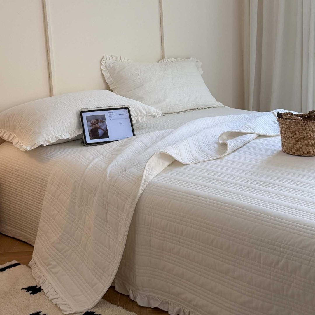 Quilted bedspread with frill and fine line quilting made of cotton blend fabric