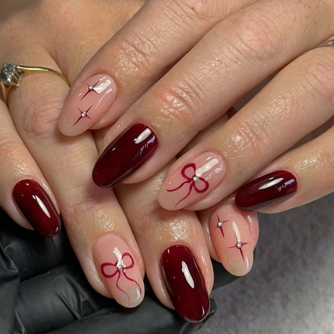 Artful nail art with elegant bows and rhinestone embellishments Kalsten