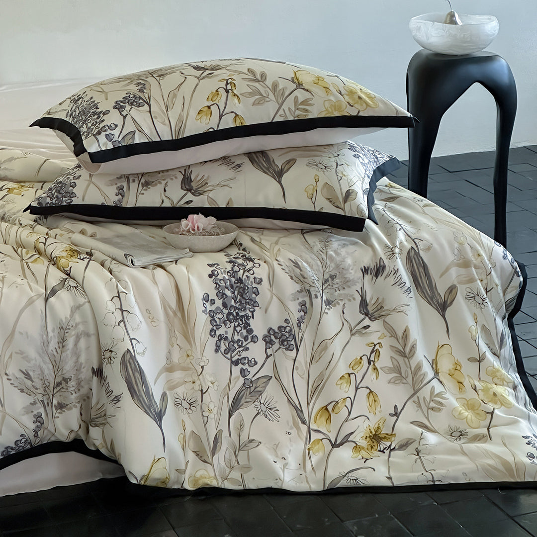 Satin bed linen set with ruffled bed skirt and floral printed pillowcases