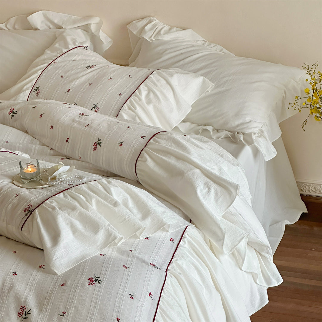 Cotton muslin bedding set with embroidered striped relief, gathered ruffle and fine piping